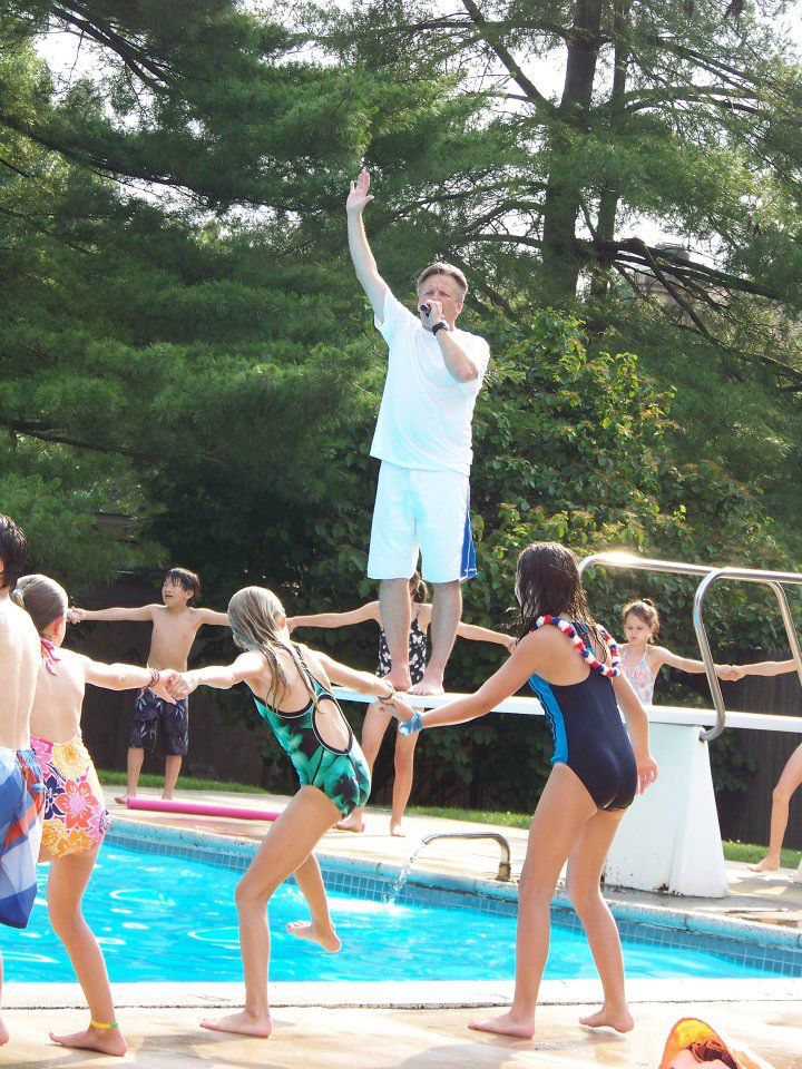 DJ on the mic leading games at a pool party